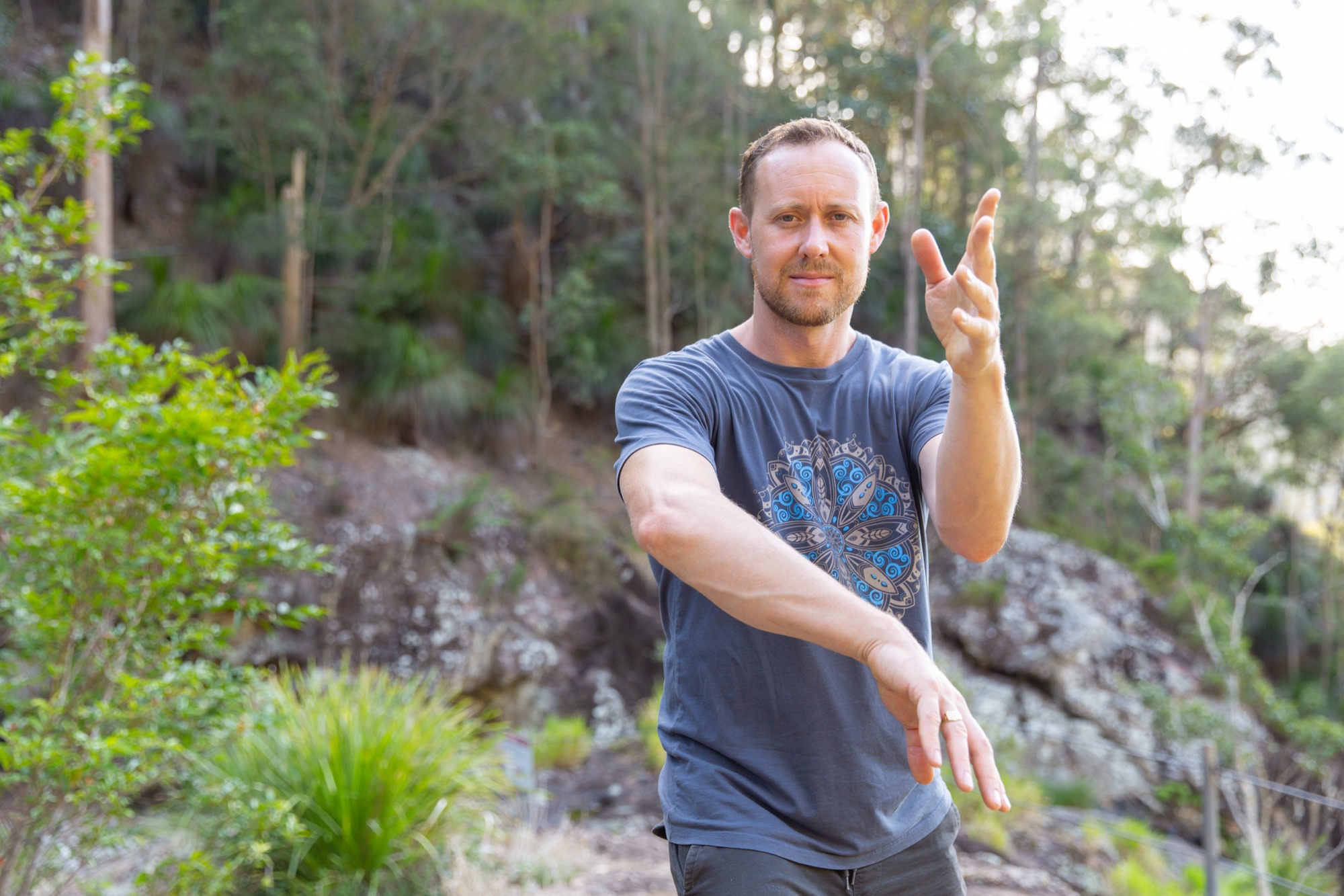 Ross Parkinson mid-Qigong movement in the bush