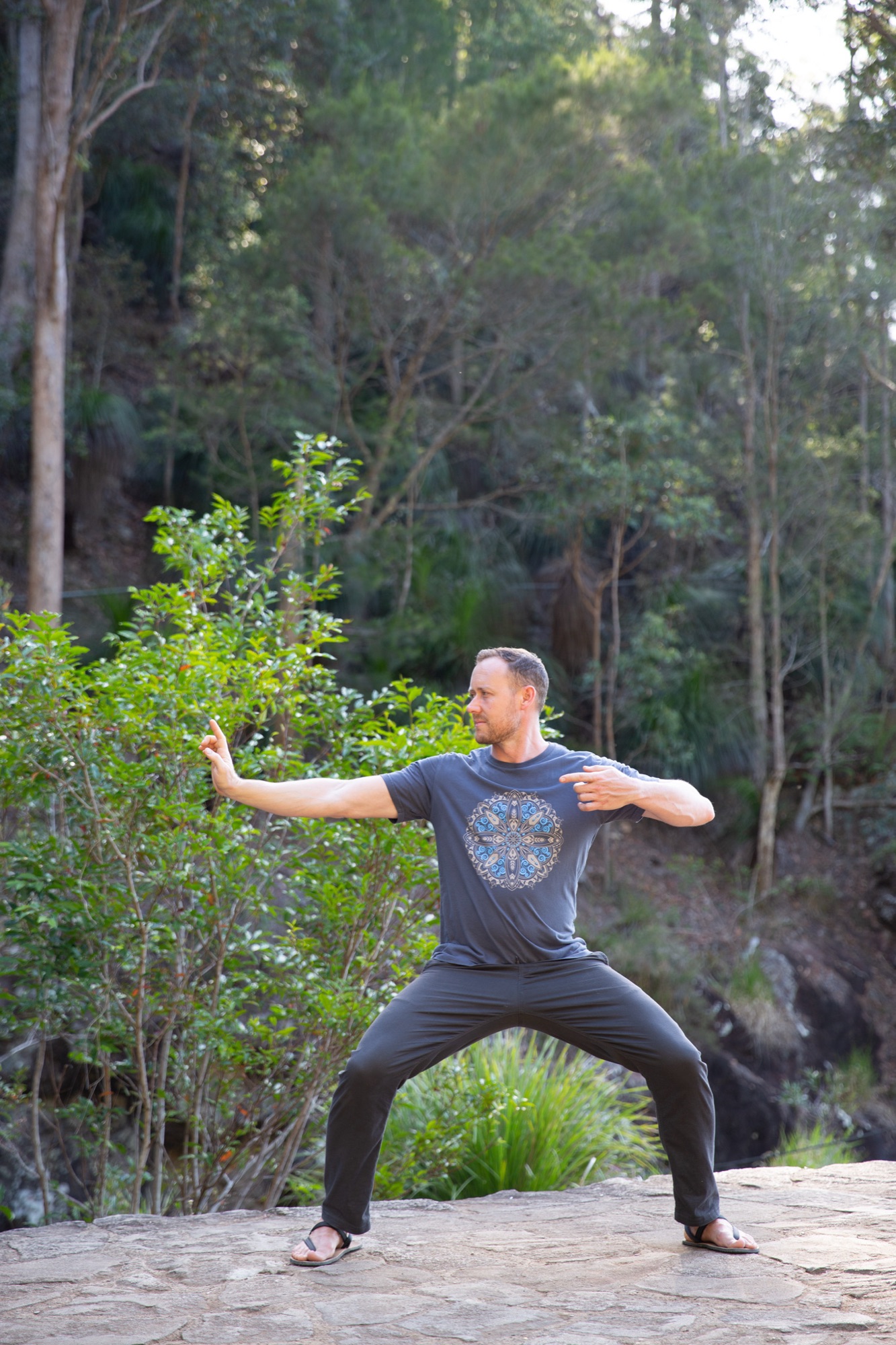 Ross Parkinson in a wide Kung Fu stance by the creek